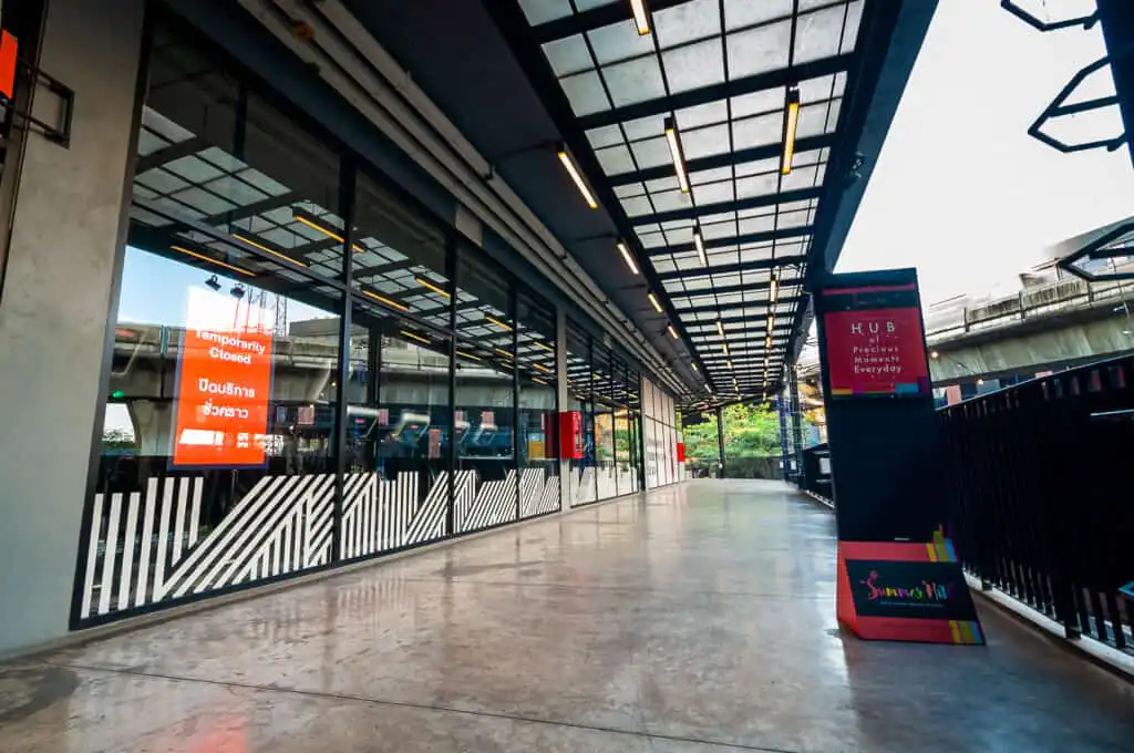 Summer Hill Sukhumvit entrance with temporarily closed sign, modern architecture, and elevated train tracks.
