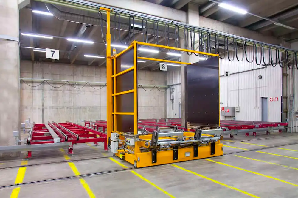 Automated guided vehicle (AGV) in a warehouse setting with numbered loading bays.