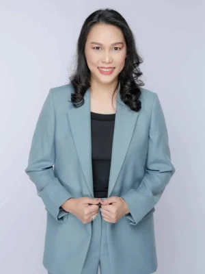 Board of Director: Professional woman in a blue suit smiles confidently at the camera.