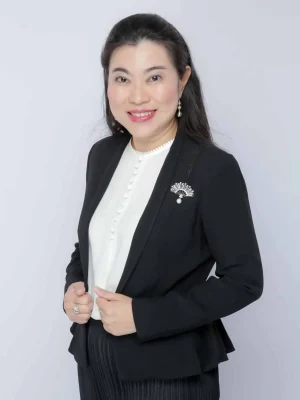 Woman in black blazer with pearl jewelry. Board of Director.